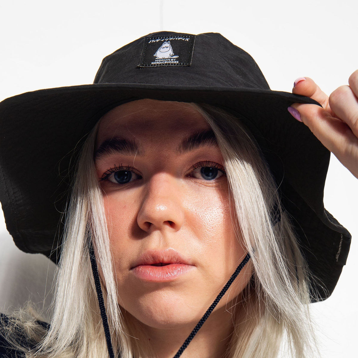 4. Close-up of female model wearing Moomintroll Brimmer Hat in black, focusing on fit and design