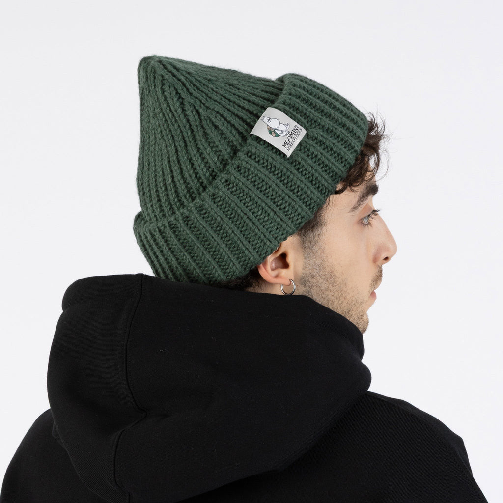 2. Side view of man wearing green Moomintroll chunky beanie by NordicBuddies with black hoodie