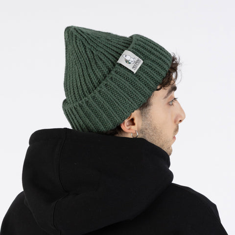 2. Side view of man wearing green Moomintroll chunky beanie by NordicBuddies with black hoodie