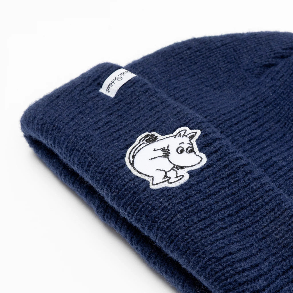 3. Close-up of navy Moomintroll beanie showing felt patch and NordicBuddies logo on ribbed acrylic fabric