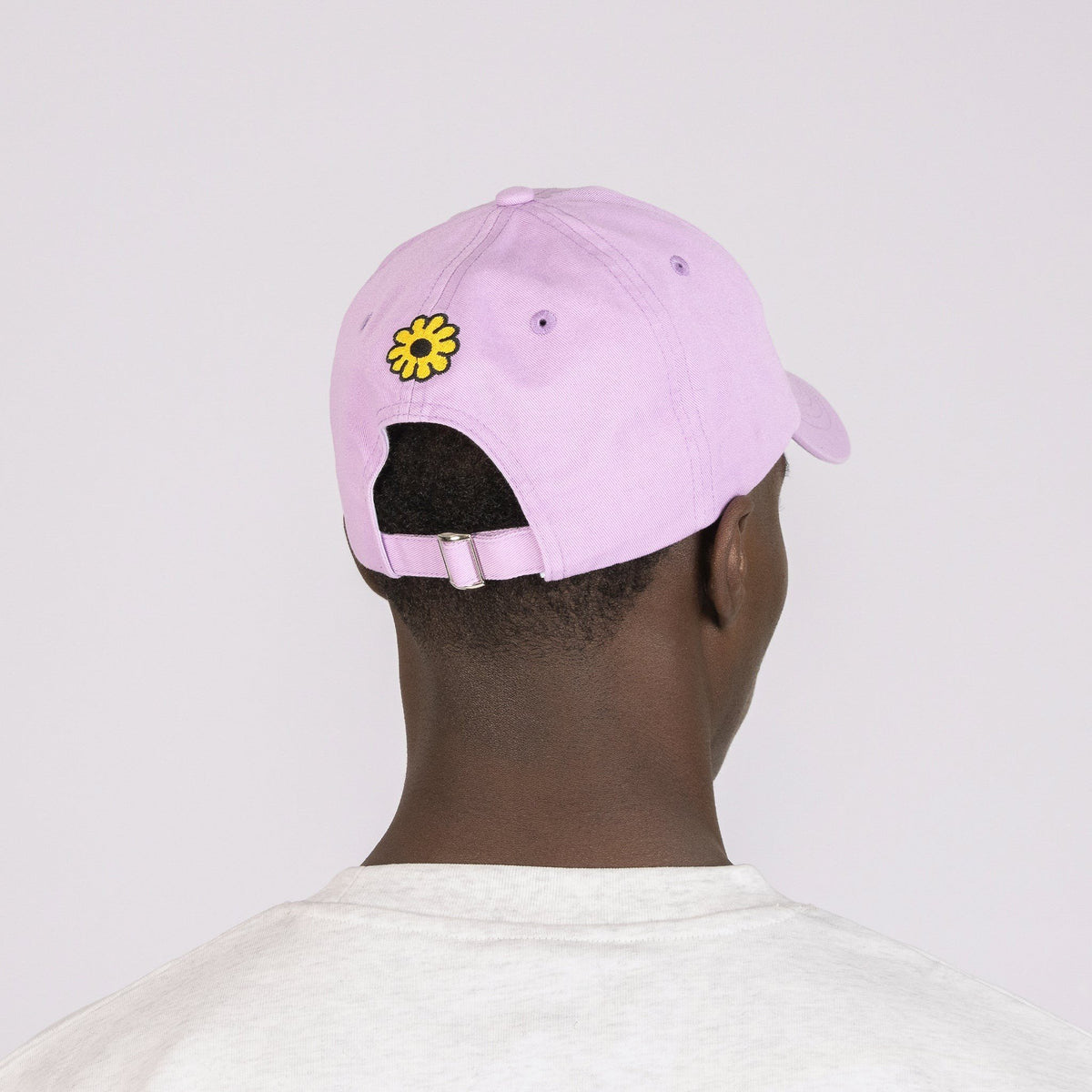 3. Back view of Moomintroll Flower Dad Cap in lavender, showing adjustable strap and flower embroidery