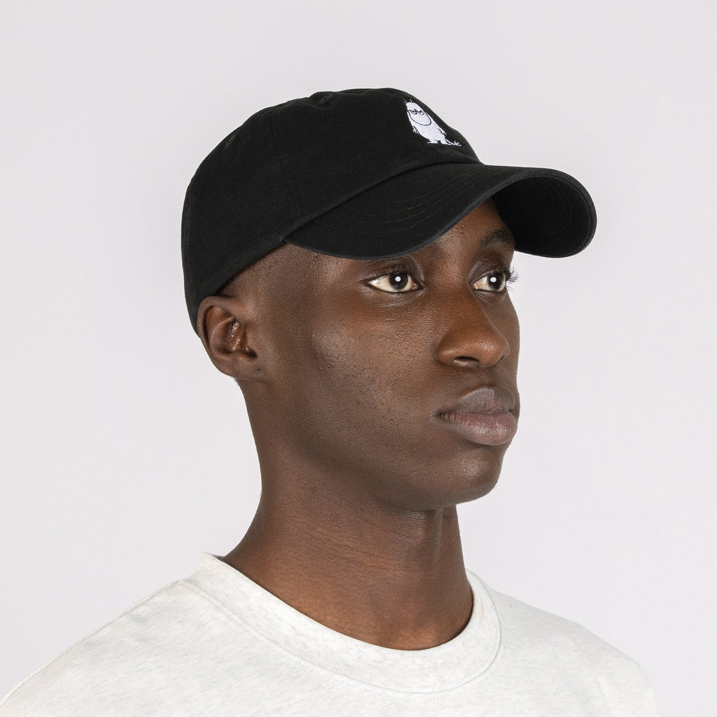 6. Side view of male model wearing Moomin by NordicBuddies black dad cap with Moomintroll embroidery