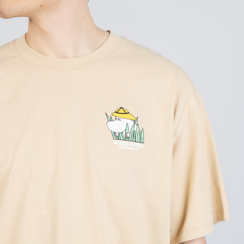 6. Close-up of front logo on beige Moomintroll Jungle T-shirt, featuring Moomin character