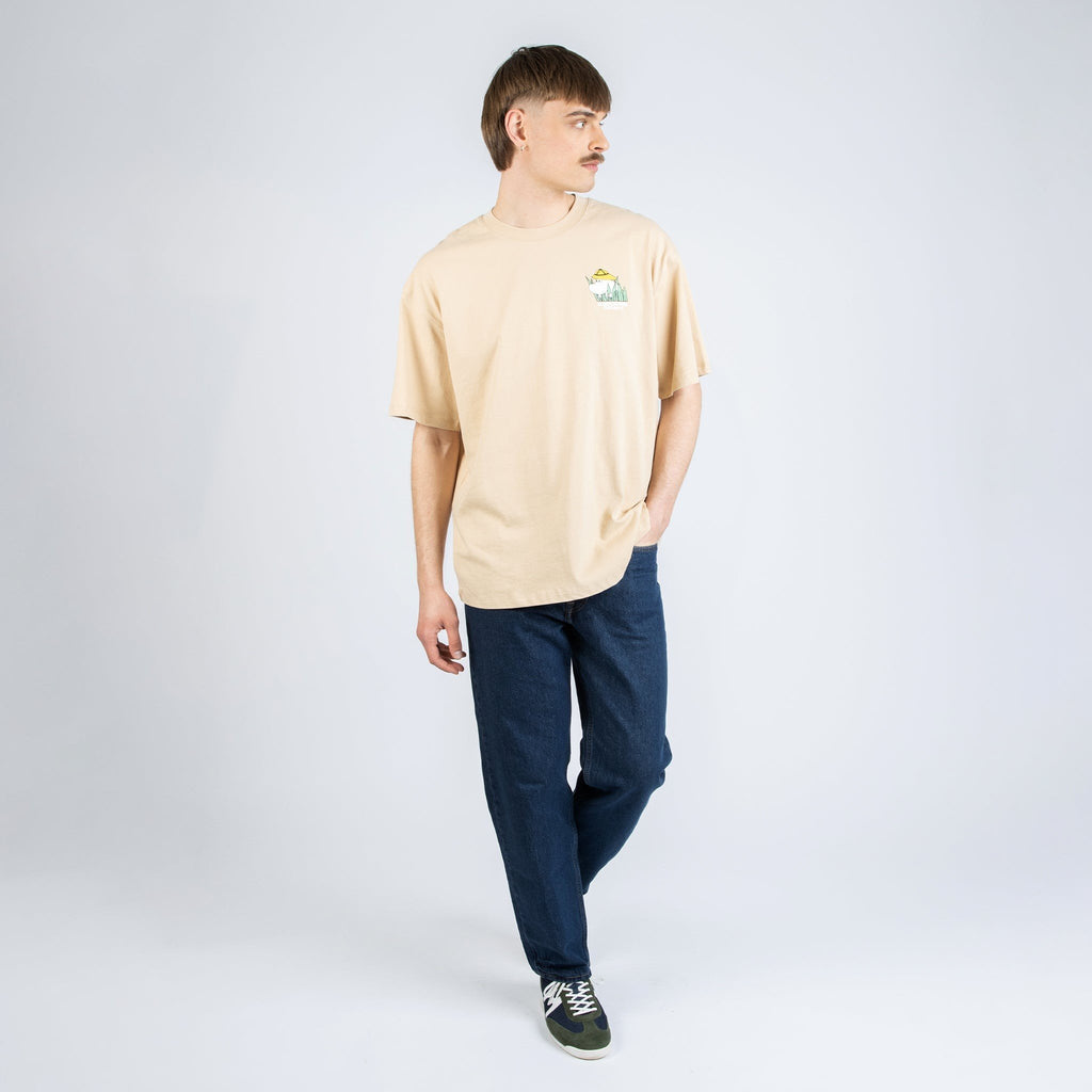2. Male model wearing beige Moomintroll Jungle T-shirt, front view in studio setting