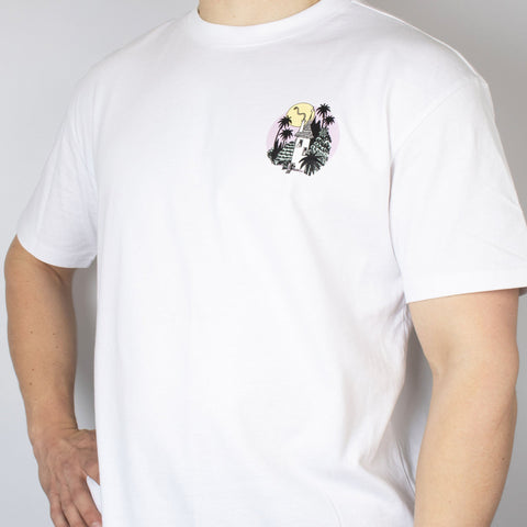 2. Man wearing white Moomintroll Jungle unisex t-shirt with small front graphic, hand on hip