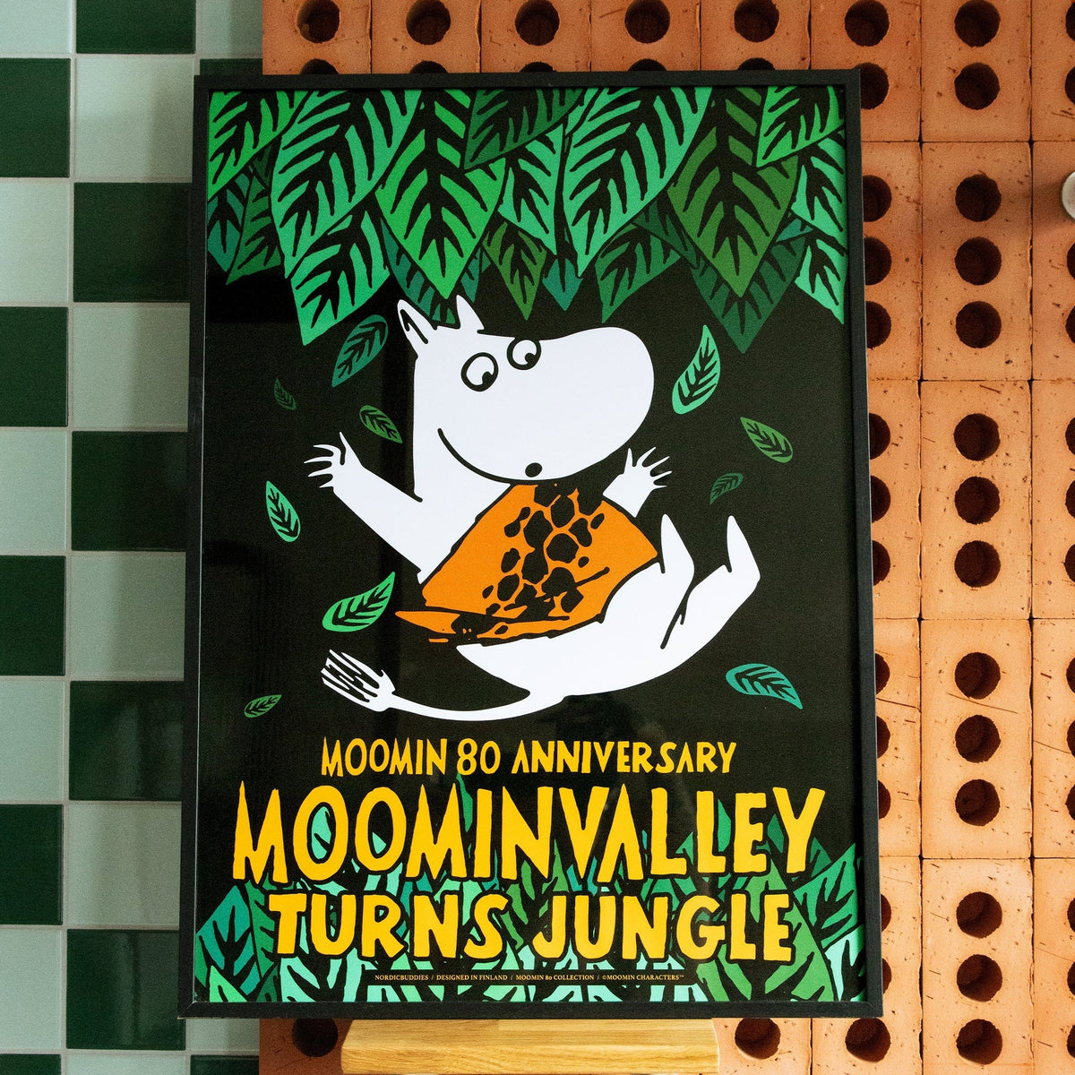 1. Moomintroll Jungle Poster by Moomin, displayed in a room setting, celebrating Moomin 80th anniversary