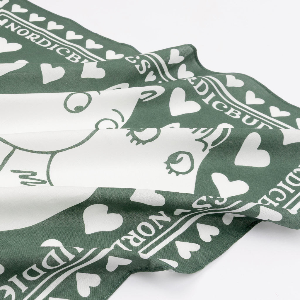 2. Close-up of green cotton scarf showing Moomintroll and Snorkmaiden design with heart pattern and NordicBuddies branding