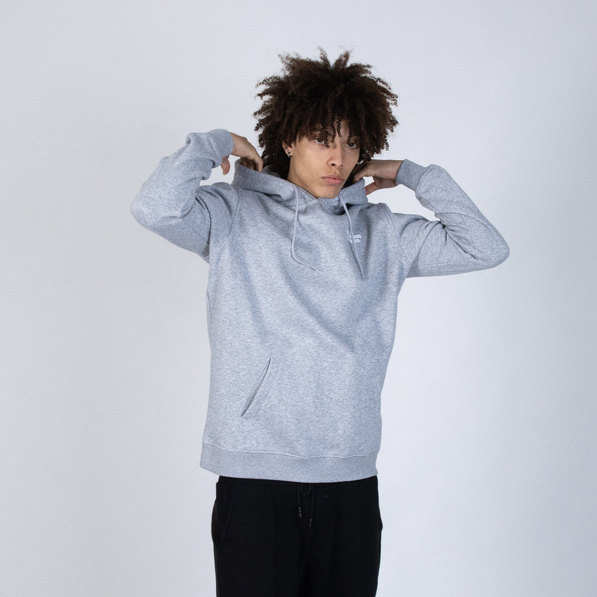 4. Unisex grey Moomintroll's Temper Hoodie worn by male model, front view in studio