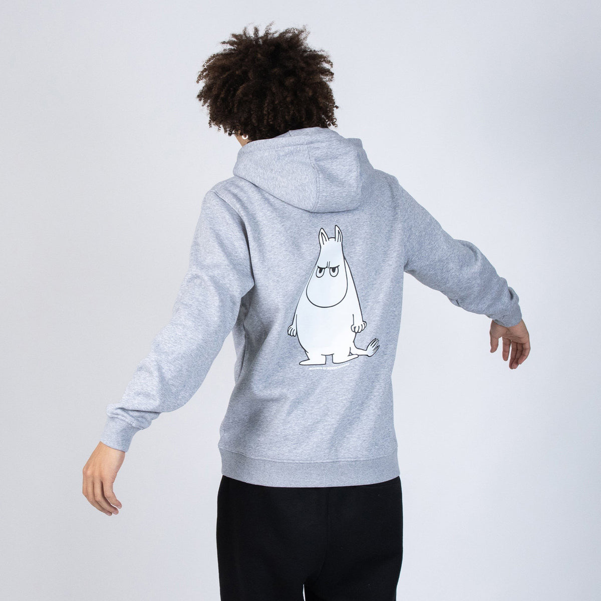 2. Unisex grey Moomintroll's Temper Hoodie shown from the back on male model in studio