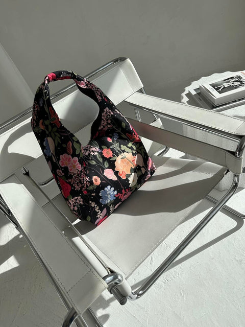 5. Garbanota Moon Bag - Curly Summer Night with floral pattern on modern chair, lifestyle setting