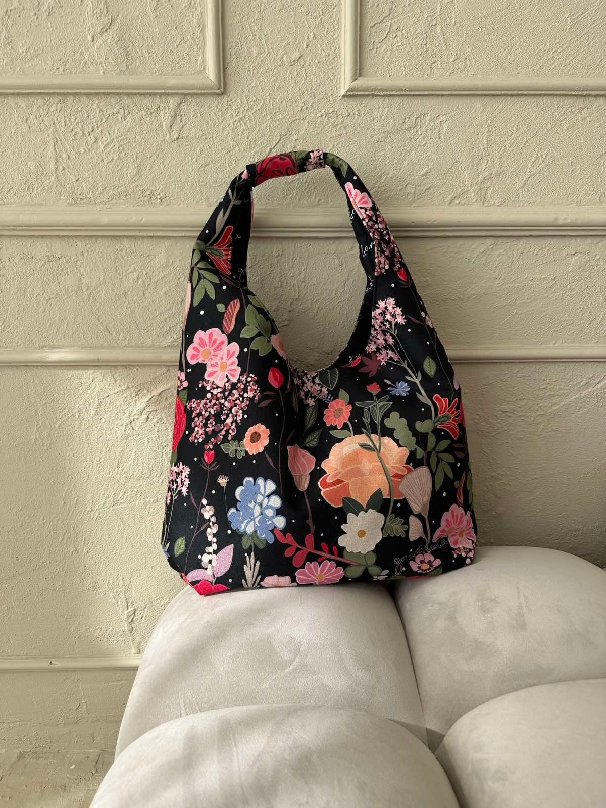 12. Garbanota Moon Bag - Curly Summer Night with floral design on white sofa, lifestyle setting