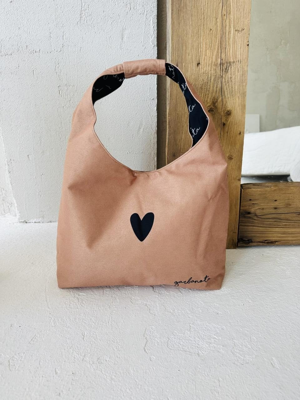 6. Garbanota Moon Bag Heart in cream, studio shot against wooden backdrop, highlighting design