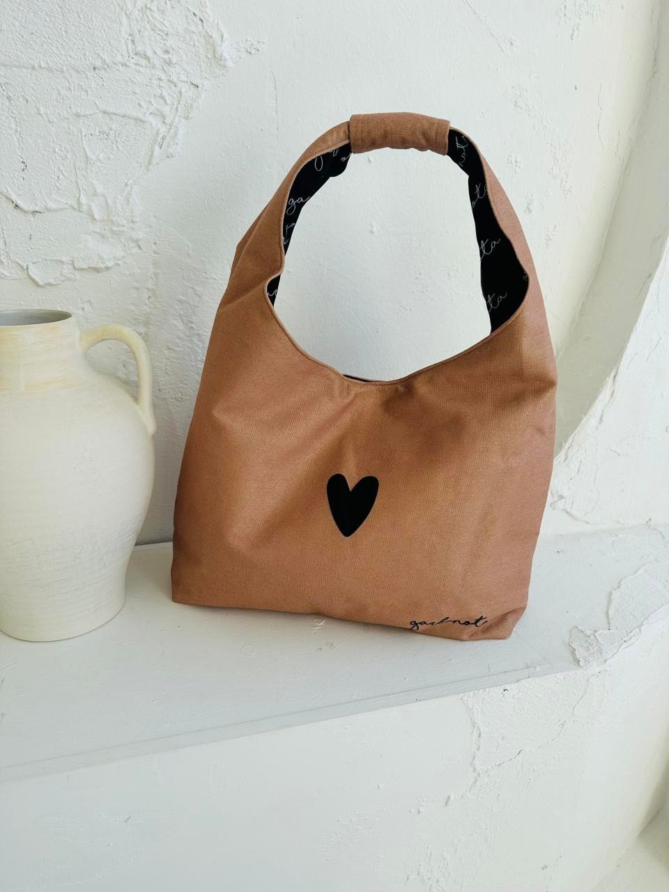 7. Garbanota Moon Bag Heart in cream, displayed with ceramic vase, showcasing heart detail