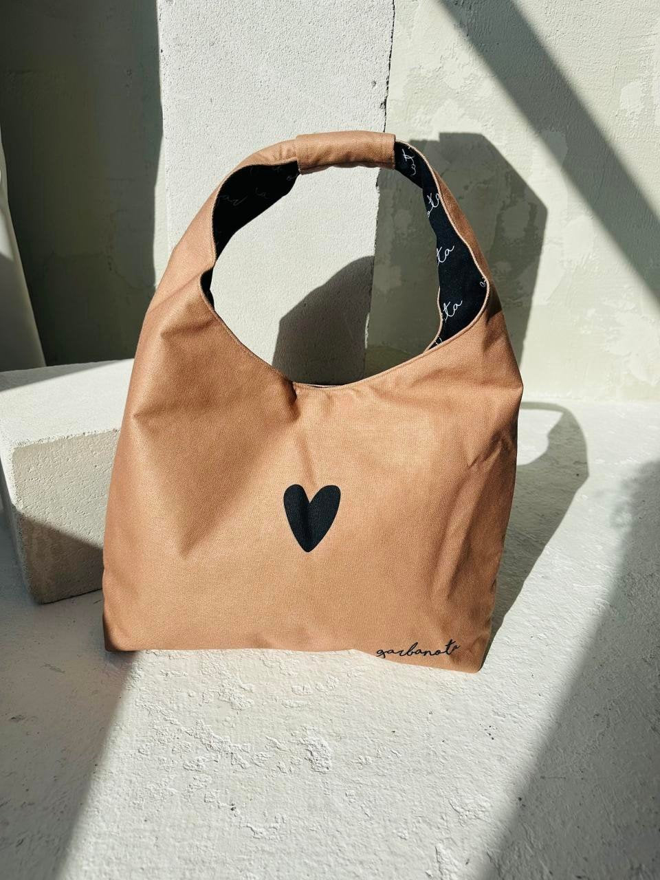 5. Garbanota Moon Bag Heart in cream, studio shot with sunlight, showing heart motif