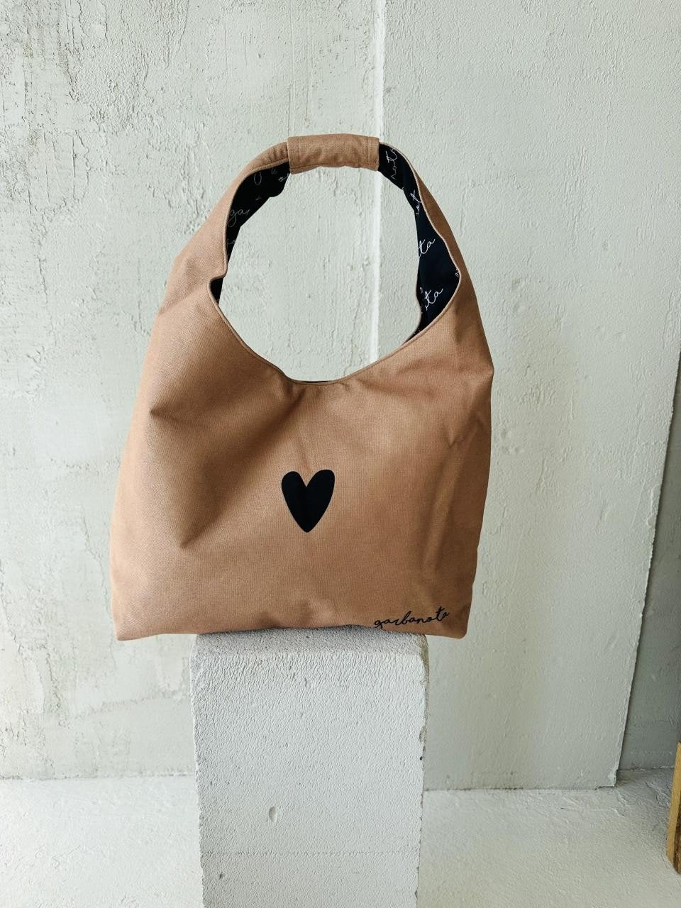 3. Garbanota Moon Bag Heart in cream, studio shot on white pedestal, showing heart design