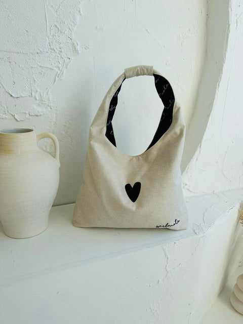 3. Garbanota Moon Bag Heart in white displayed on a white surface, showing heart detail
