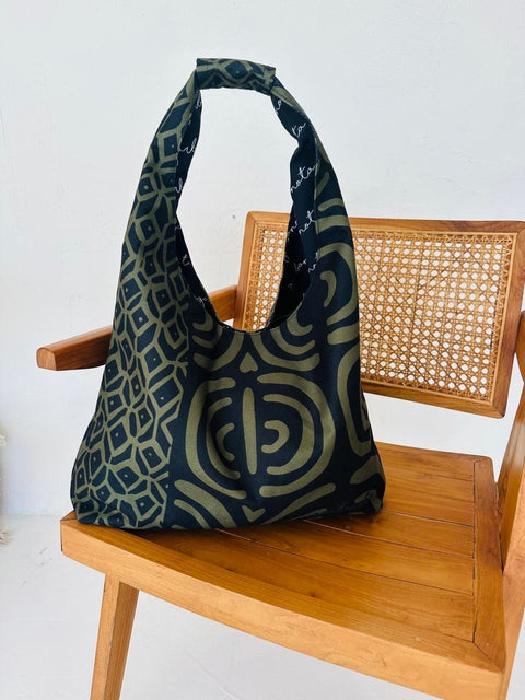 4. Garbanota Moon Bag in khaki pattern on a wooden chair, showcasing intricate pattern