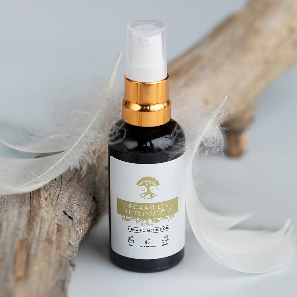 1. HOIA homespa Natural Castor Oil 50 ml bottle with gold pump, displayed on driftwood with feathers, highlighting organic and vegan features