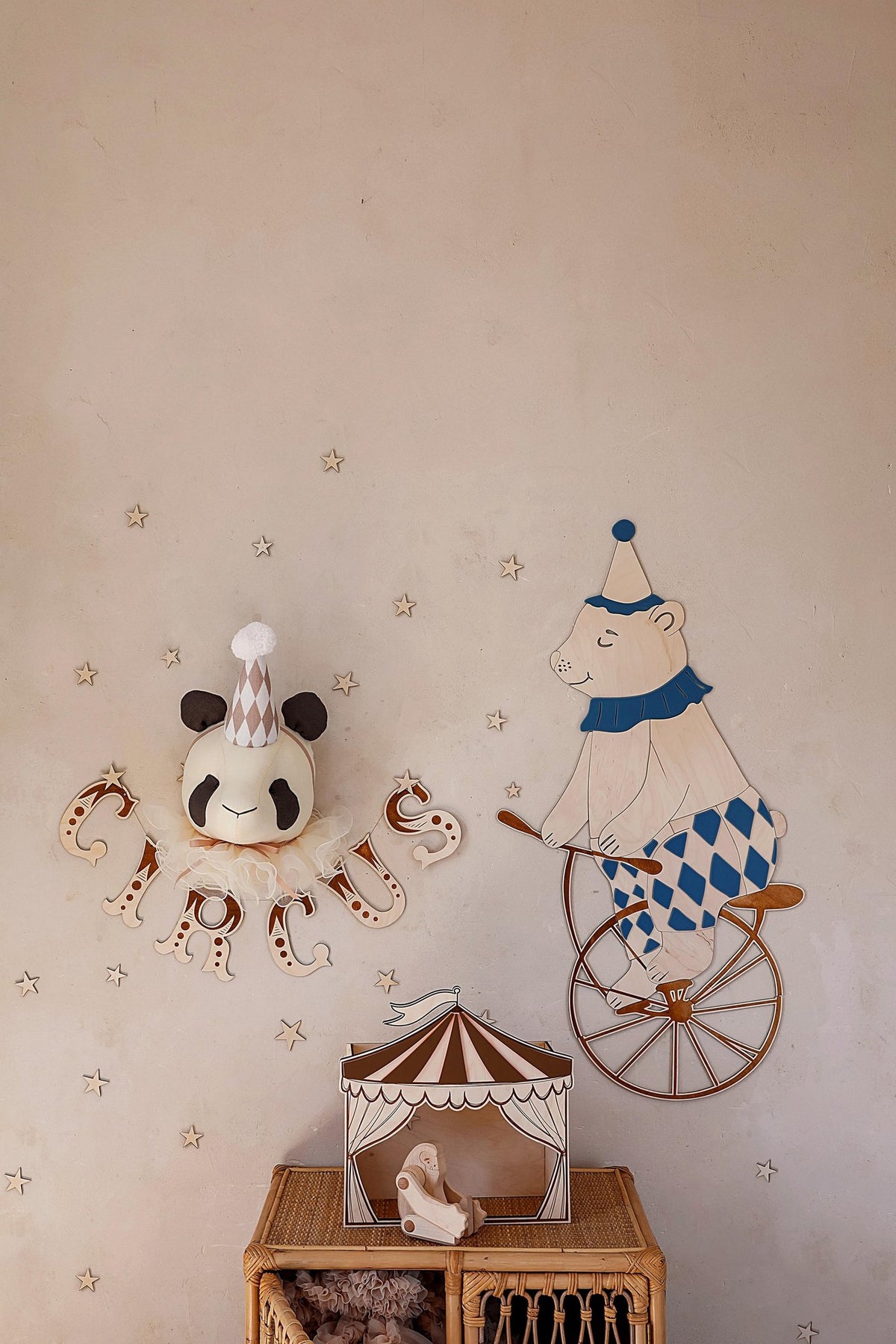 4. Wooden wall garland spelling 'CIRCUS' with a panda head and bear on a unicycle in a child's room