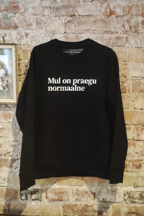1. Black Heavy Mental pullover sweatshirt with 'Mul on praegu normaalne' text, shown hanging against a brick wall