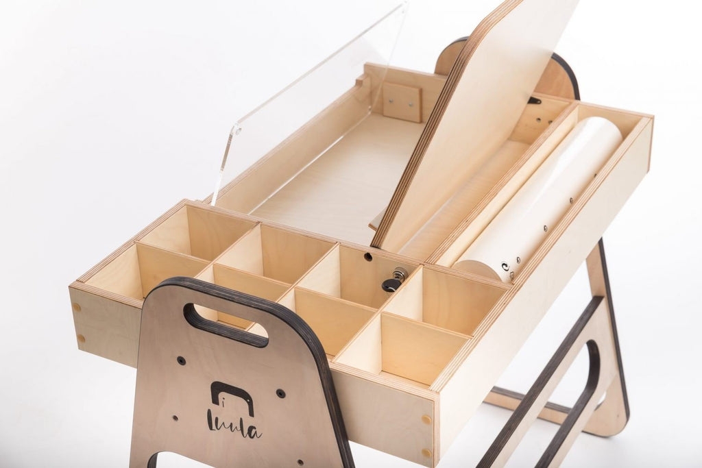 3. Close-up of Luula Julle table showing storage compartments, acrylic board, and paper roll