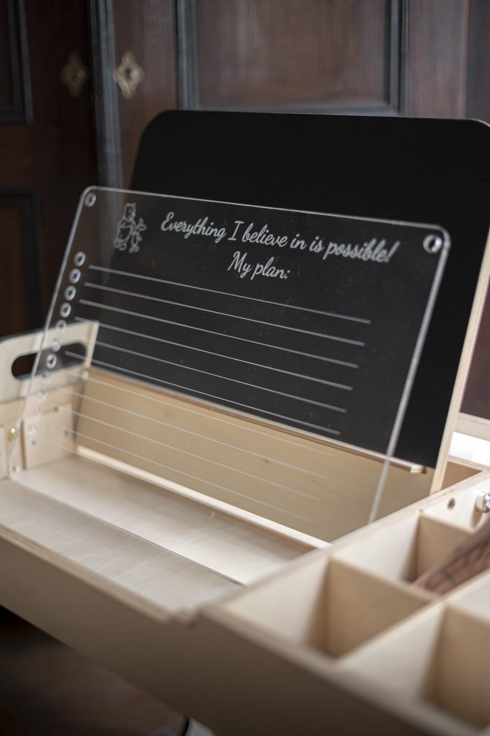 3. Close-up of Luula Julle table with acrylic board displaying motivational text