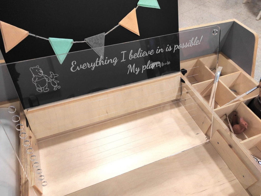 10. Close-up of Luula table's acrylic board with motivational text and decorative elements, showcasing customization