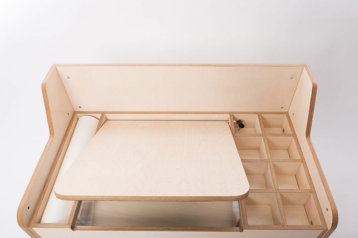 11. Flat lay of Luula table showing paper roll, adjustable surface, and storage compartments
