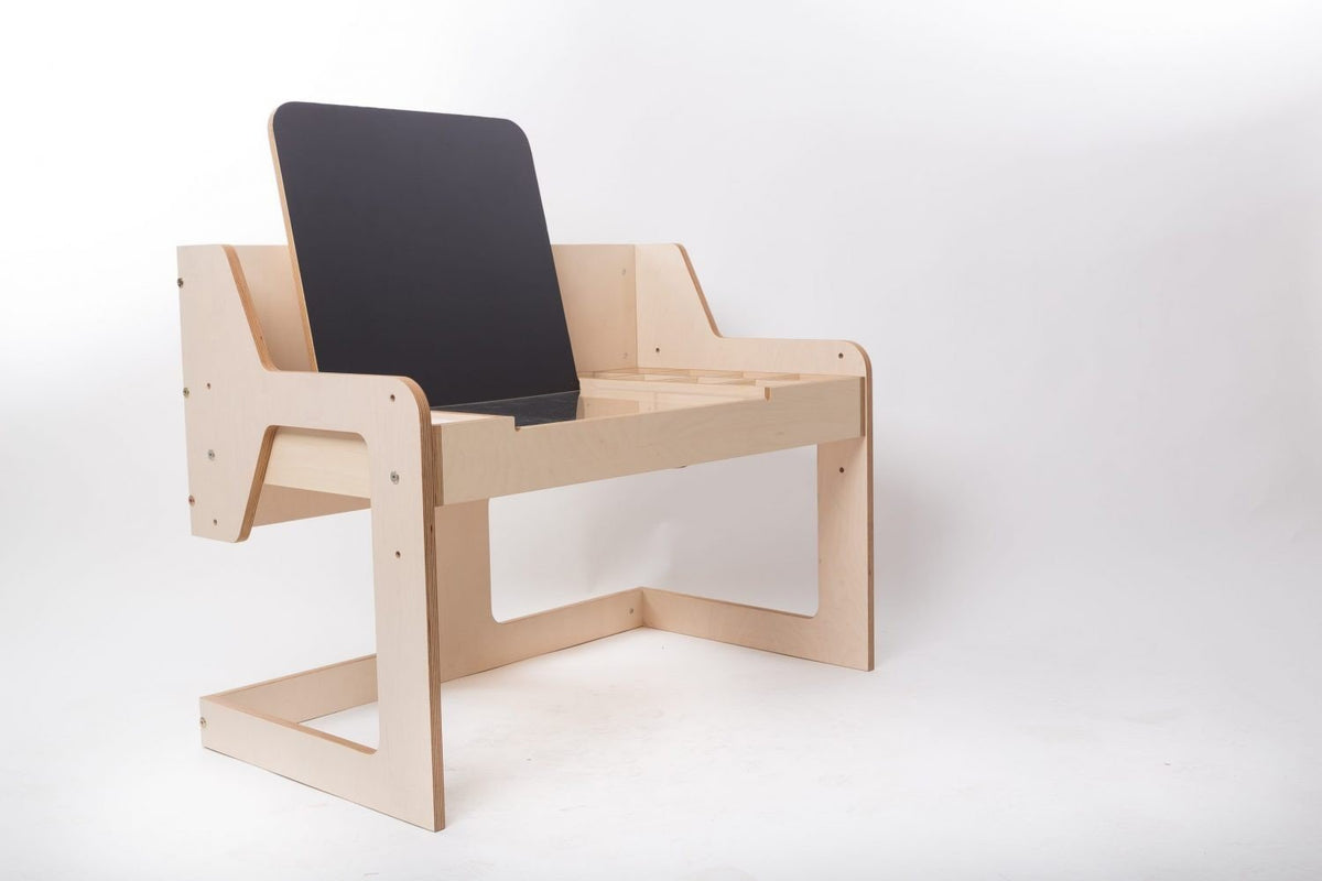 14. Luula table with chalkboard in studio setting, showcasing adjustable height and birch plywood material