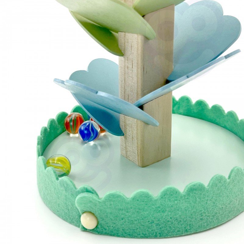 8. Detail of colorful marbles and green felt base of wooden ball track