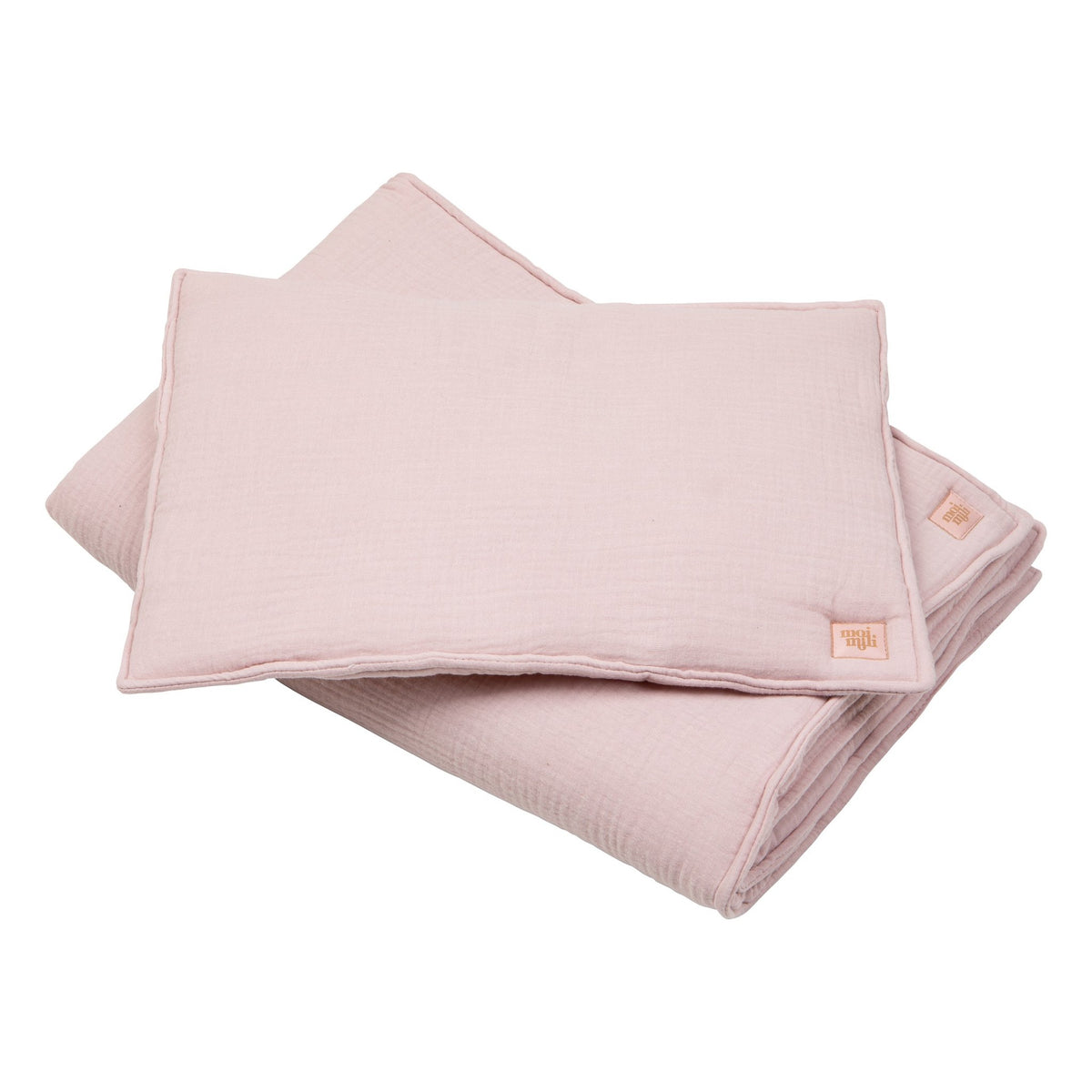 1. Baby pink muslin blanket and pillow set with sewn-in filling, shown folded on a white background, featuring Moi Mili brand tag