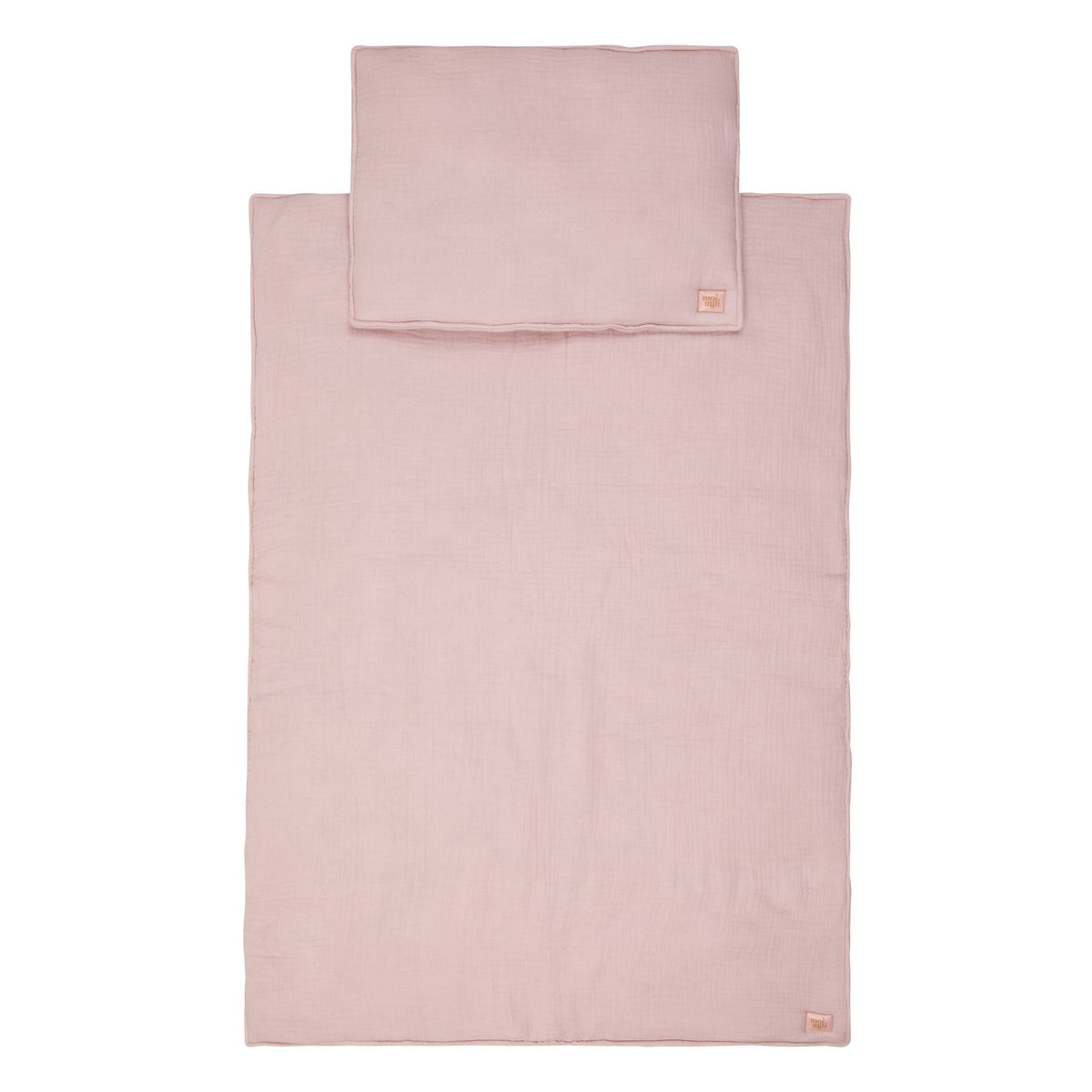 2. Flat lay of baby pink muslin blanket and pillow set with Moi Mili brand tag, displayed on a white background