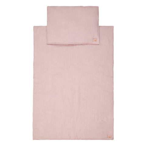 2. Flat lay of baby pink muslin blanket and pillow set with Moi Mili brand tag, displayed on a white background
