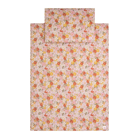 3. Flat lay of muslin baby blanket and pillow set with pink, yellow, and white floral pattern