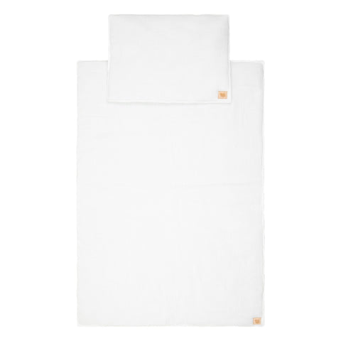 4. Flat lay of cream muslin baby blanket and pillow set with Moi Mili logo