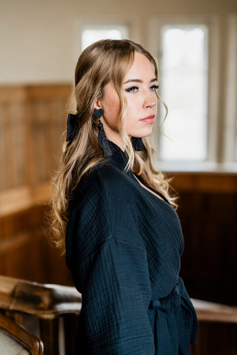 2. Close-up of women's black muslin kimono by RÄTT, highlighting textured fabric and waist belt