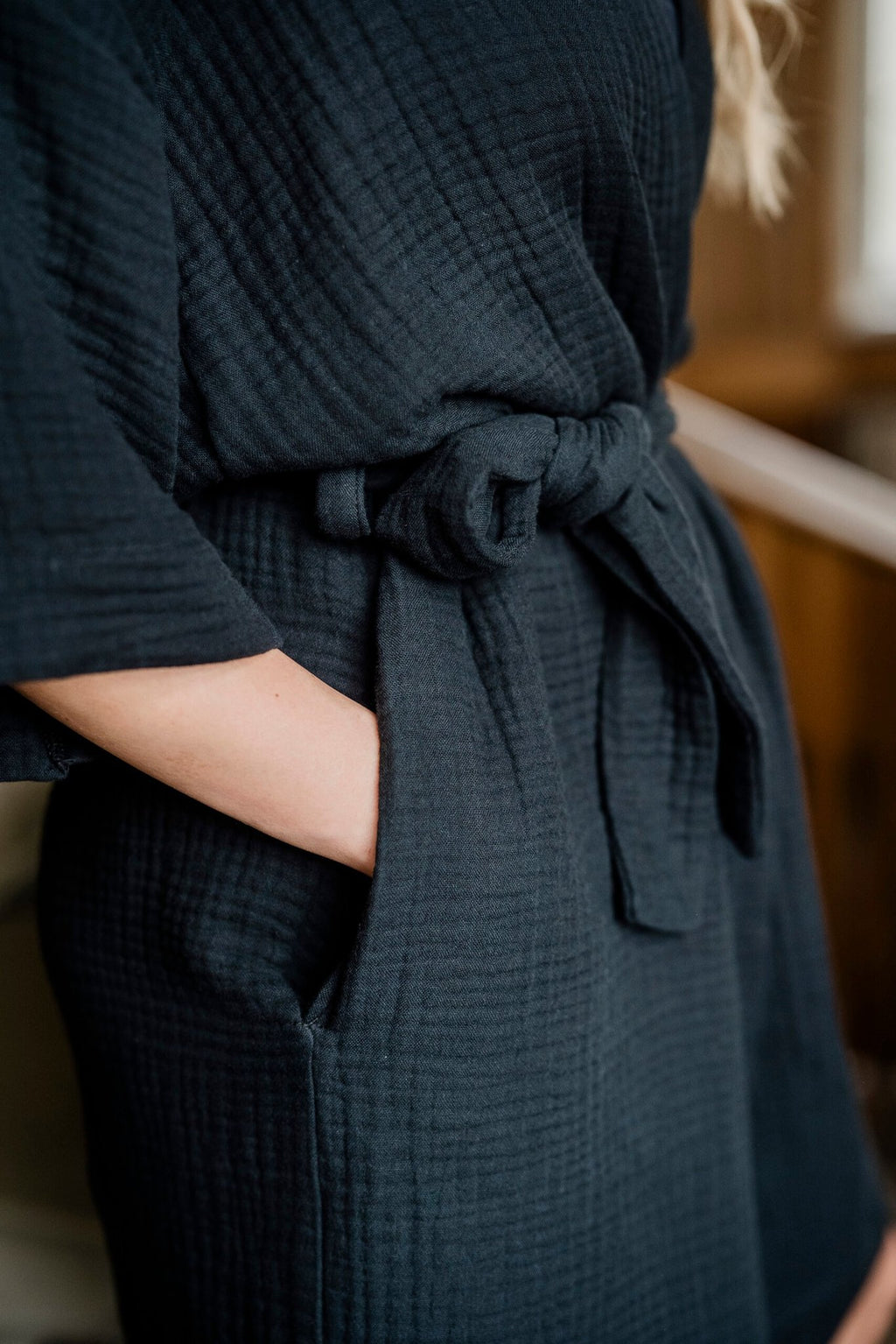 3. Detail of side pocket and waist belt on women's black muslin kimono by RÄTT