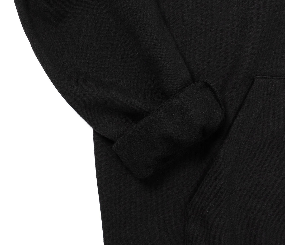5. Close-up of sleeve and pocket detail on black Moomin hoodie, highlighting fabric texture