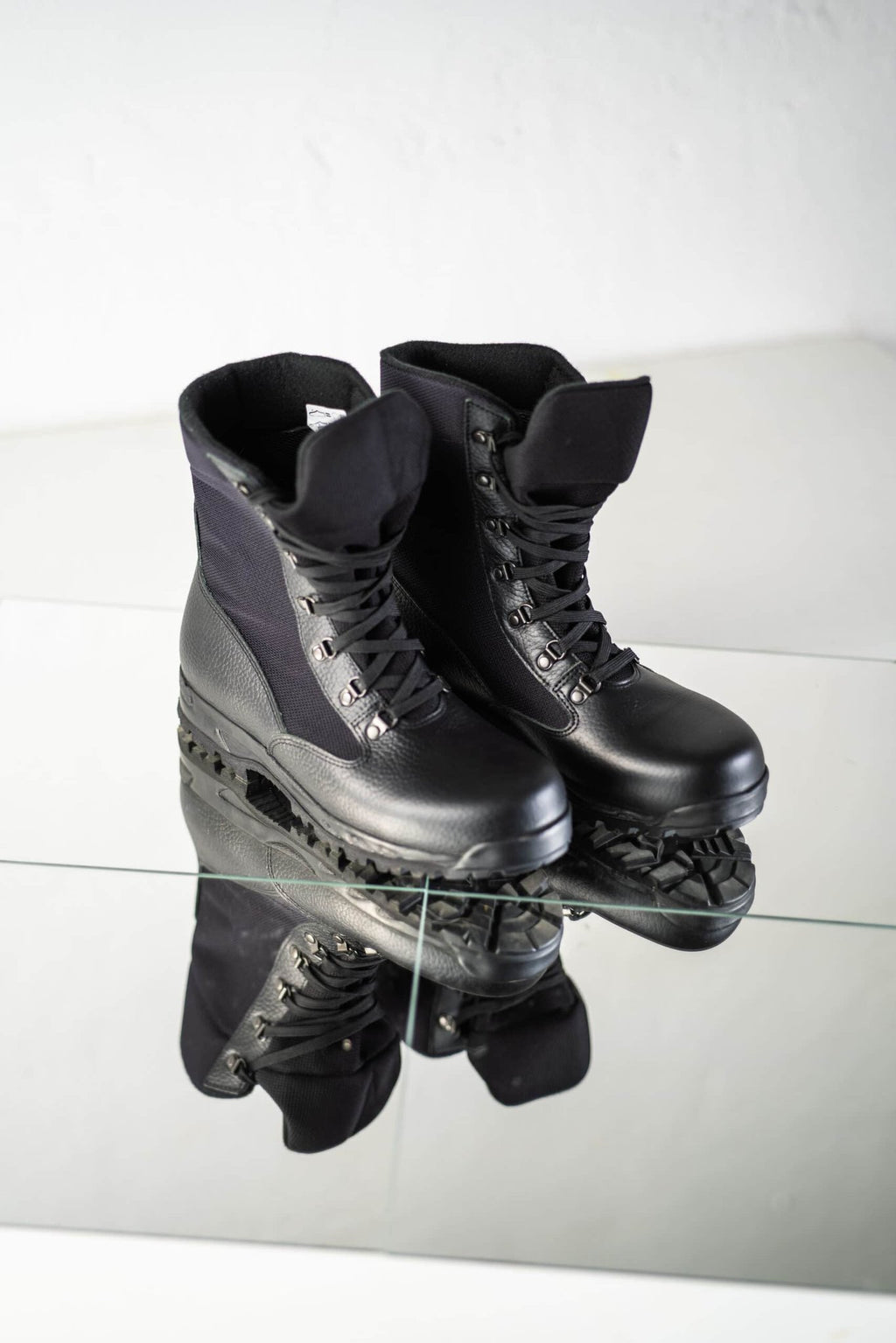 6. Pair of black Samelin 598 Desert Boots Davos on reflective surface in studio setting
