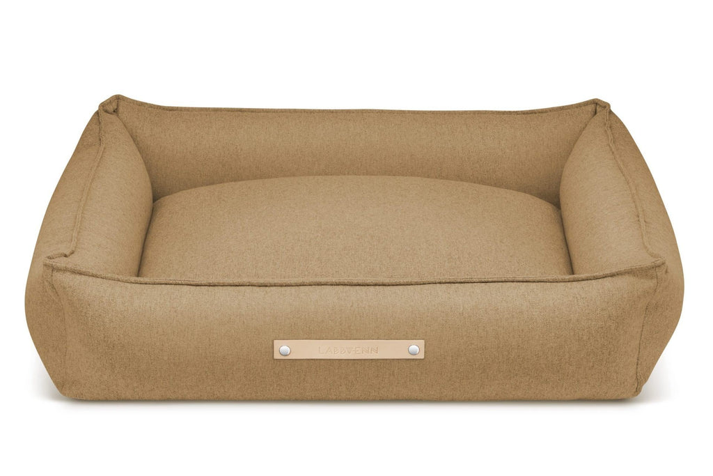 2. Labbvenn Møvik dog bed in biscuit color with leather logo tag, shown in studio setting