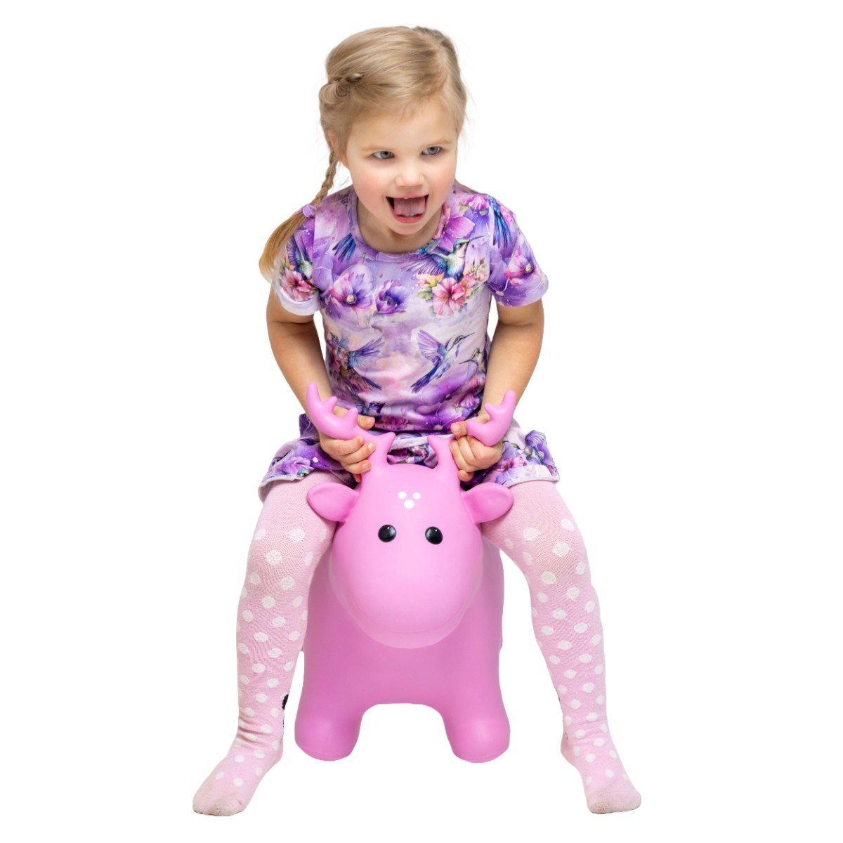 1. Girl wearing floral dress and pink polka dot tights sitting on pink moose hopper toy
