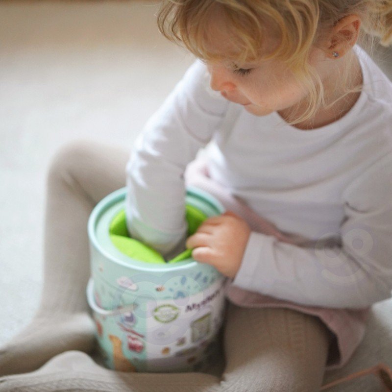 2. Young girl playing with Woopie Mystery Box, reaching inside to find a shape