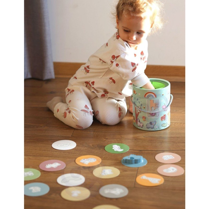 9. Child engaging with Woopie Mystery Box, surrounded by matching cards