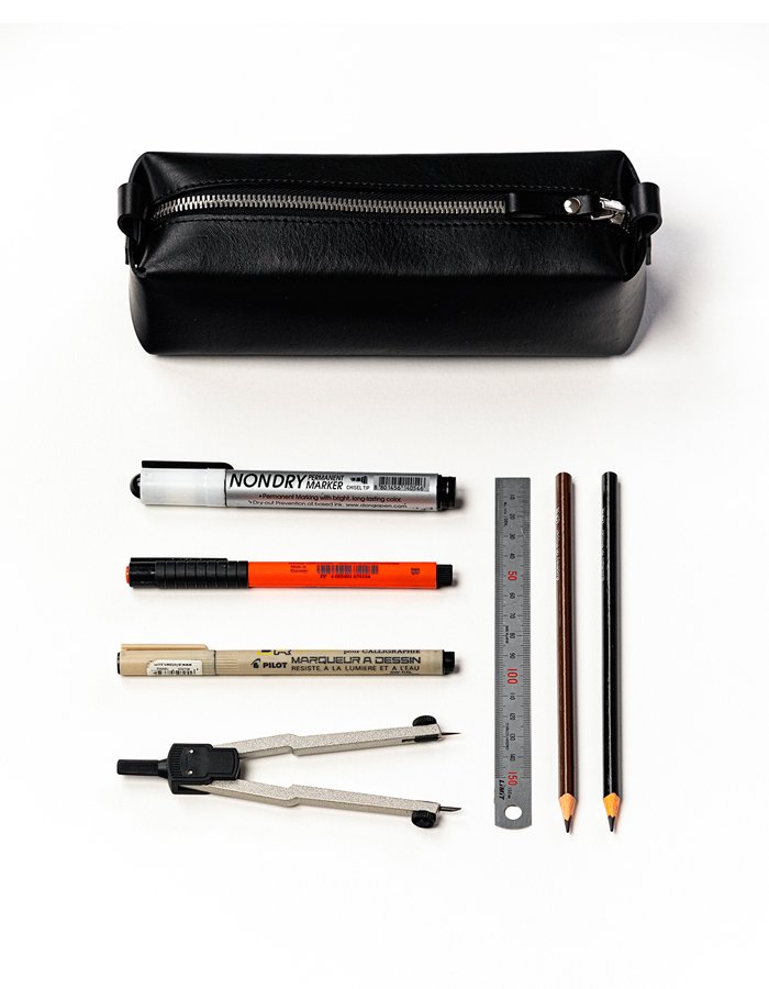 2. Black leather pencil case by Stella Soomlais with various stationery items including pens, pencils, and a ruler, highlighting capacity and functionality