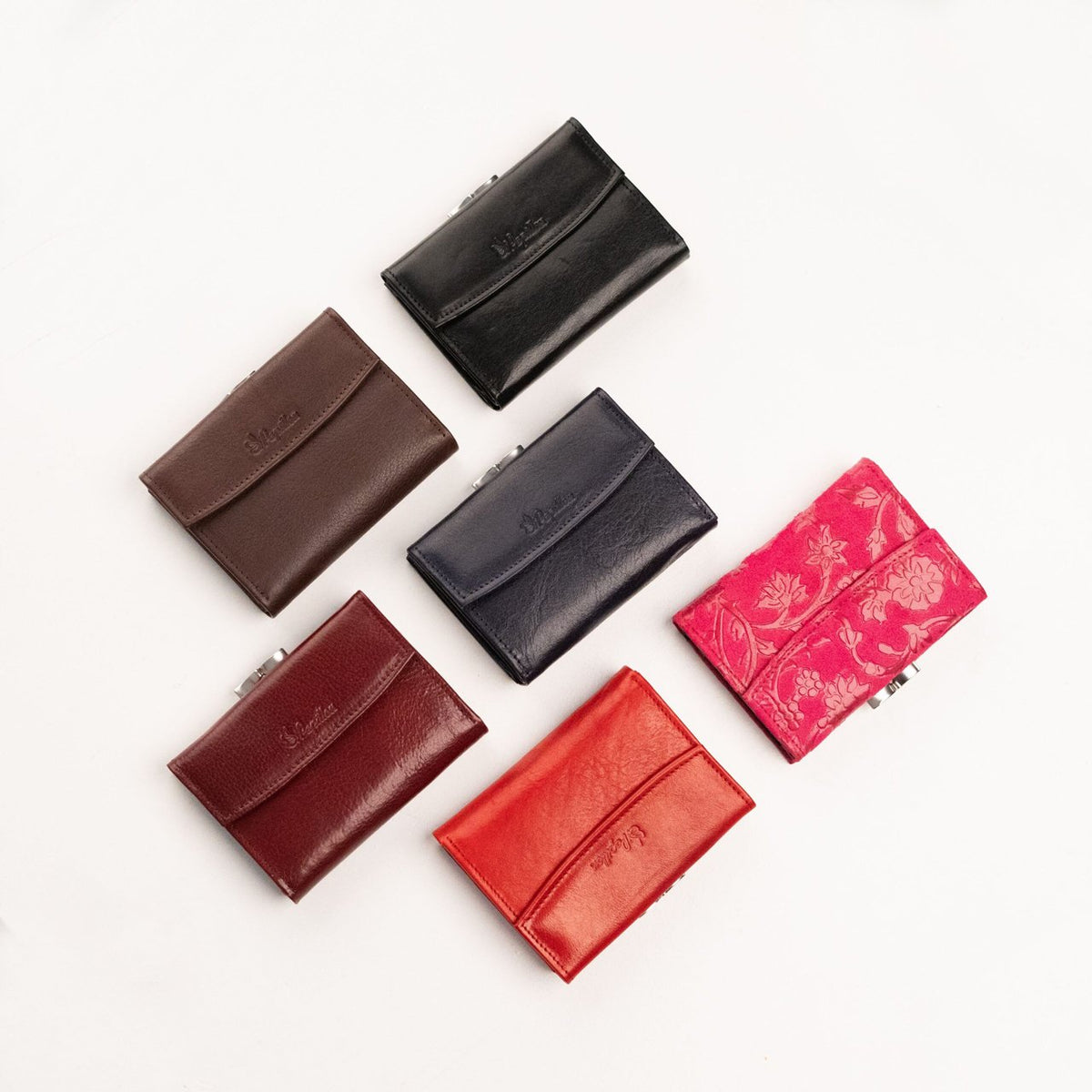 18. Assorted Papillon women's leather wallets in various colors, showcasing compact design and craftsmanship