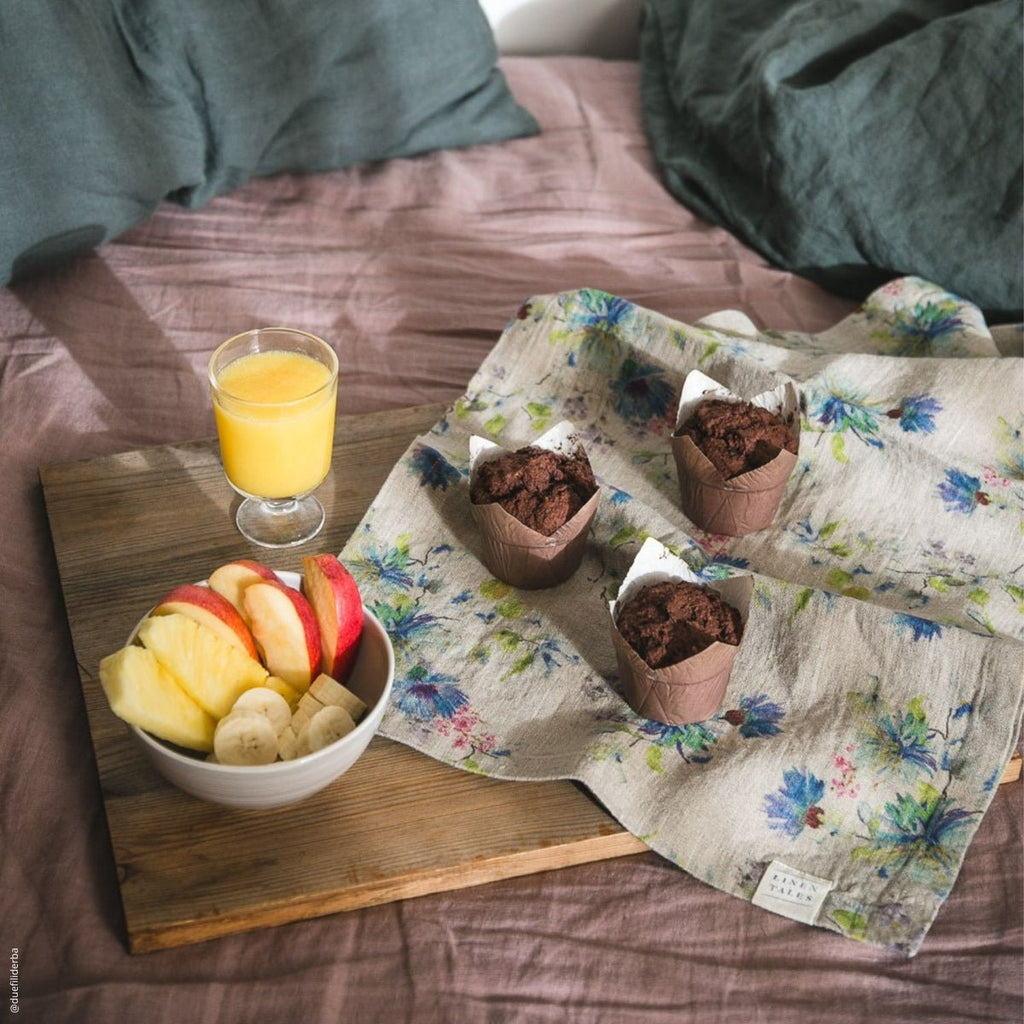 6. Floral linen napkin with muffins and fruit on a wooden board for a cozy breakfast setting