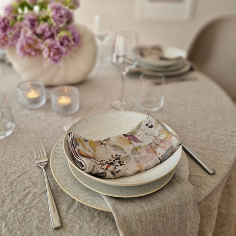 5. Floral linen napkin in a bowl on a set dining table with candles and flowers