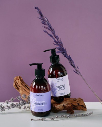 1. Nurme lavender hand and body wash and lotion set on wooden surface with lavender sprig against purple background