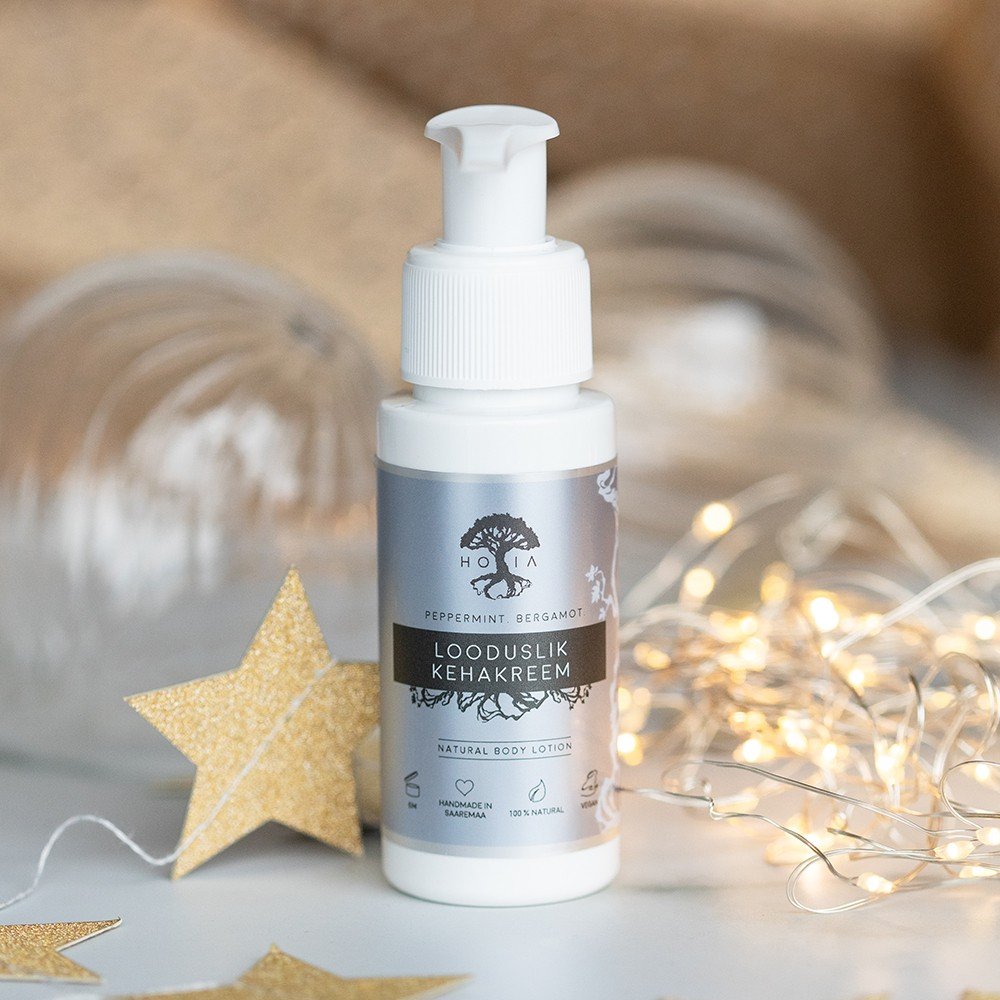 1. HOIA homespa natural body cream in 50 ml pump bottle with peppermint and bergamot scent, surrounded by decorative lights and stars, suitable for all skin types, made in Estonia