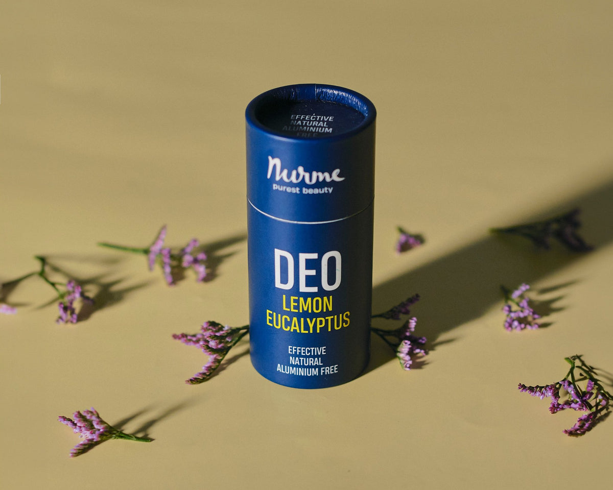 3. Nurme lemon eucalyptus deodorant on yellow background with scattered purple flowers